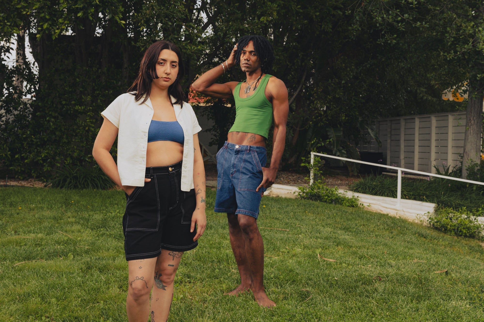 Betty Rosado is wearing Carpenter Shorts in Black and Pantry Button-Up in Vintage Tee Off-White. Jerrod is wearing Carpenter Shorts in Dark Wash and a Cropped Tank in Lawn Green.