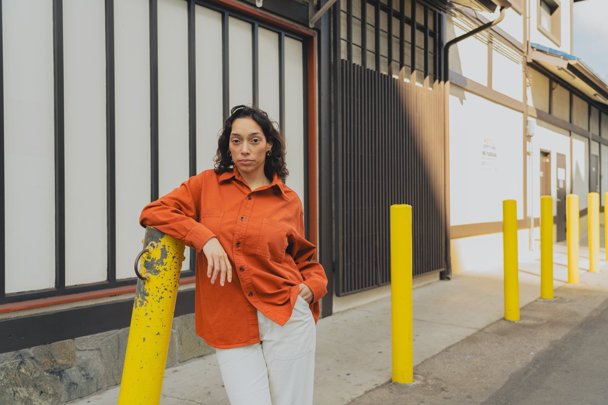 Tiara is wearing Twill Overshirt in Burnt Terracotta and Work Pants in Vintage Tee Off-White