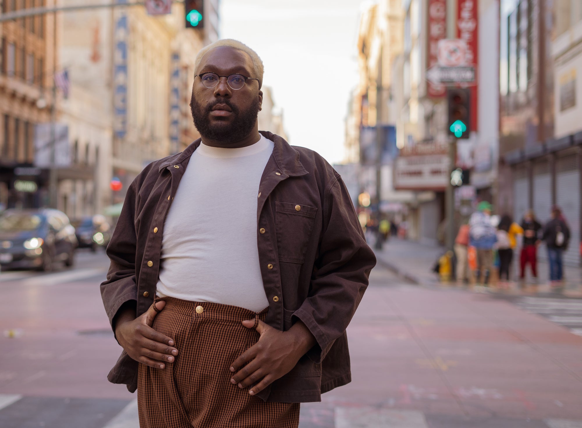 Elijah is wearing Denim Work Jacket in Espresso Brown, Organic Vintage Tee in Vintage Off-White, and Checker Trousers in Brown