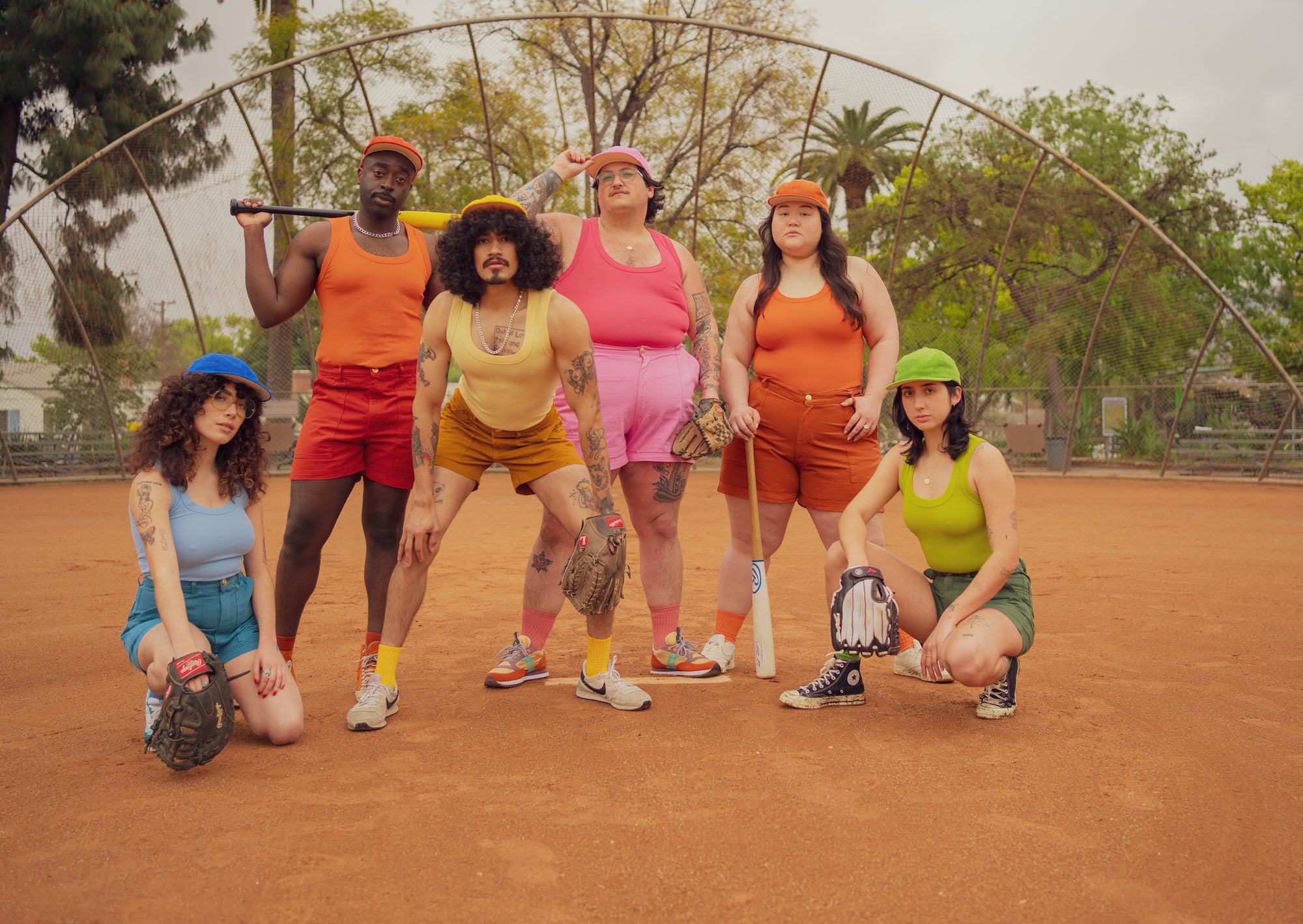 Rene, Eli, Jesse, Sam, Ashley and Betty all wearing Dug Out Hats, The Tank Top, and Work Shorts in a variety of hues.