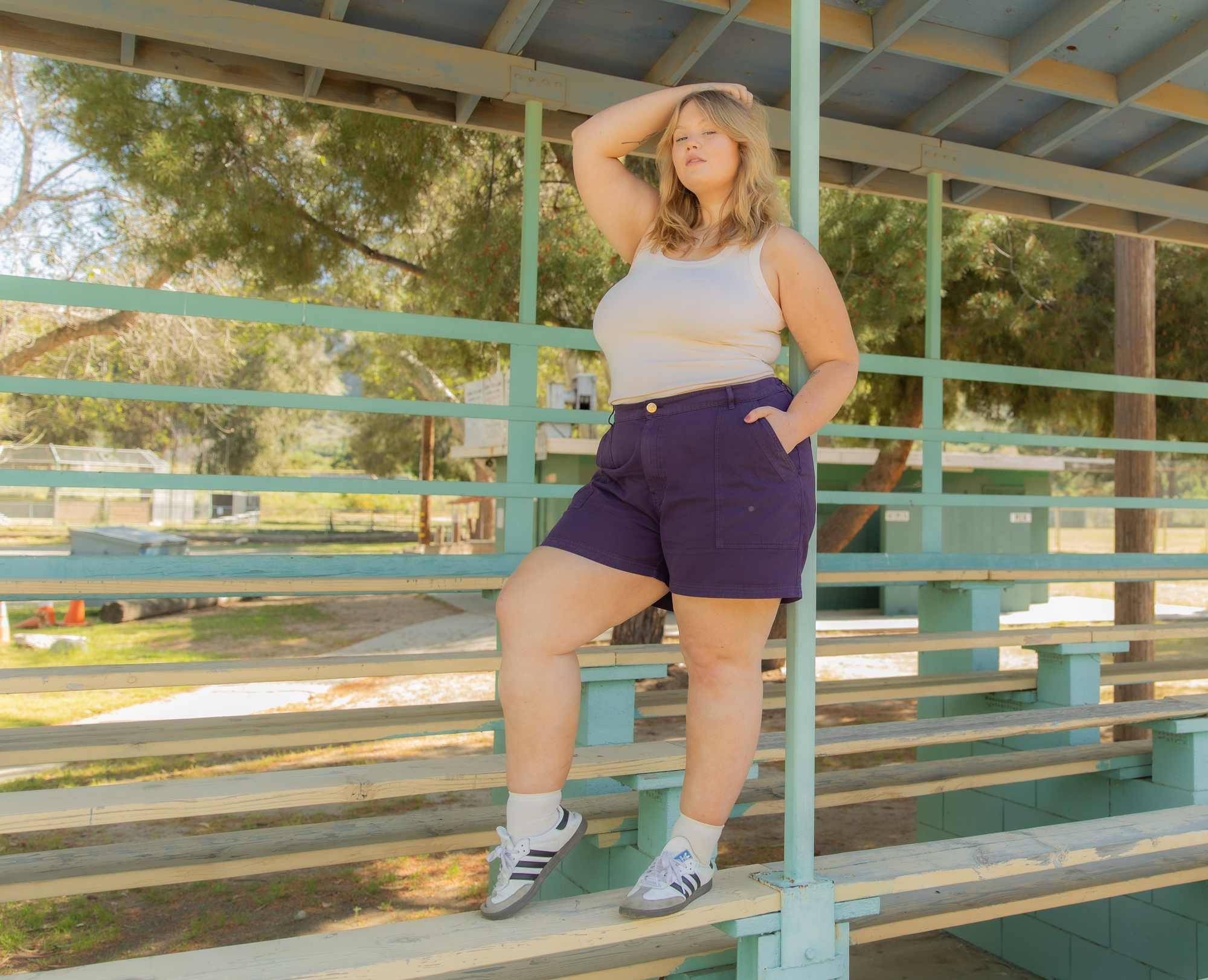 Juliet is wearing Tank Top in Vintage Tee Off-White and Work Shorts in Nebula Purple.