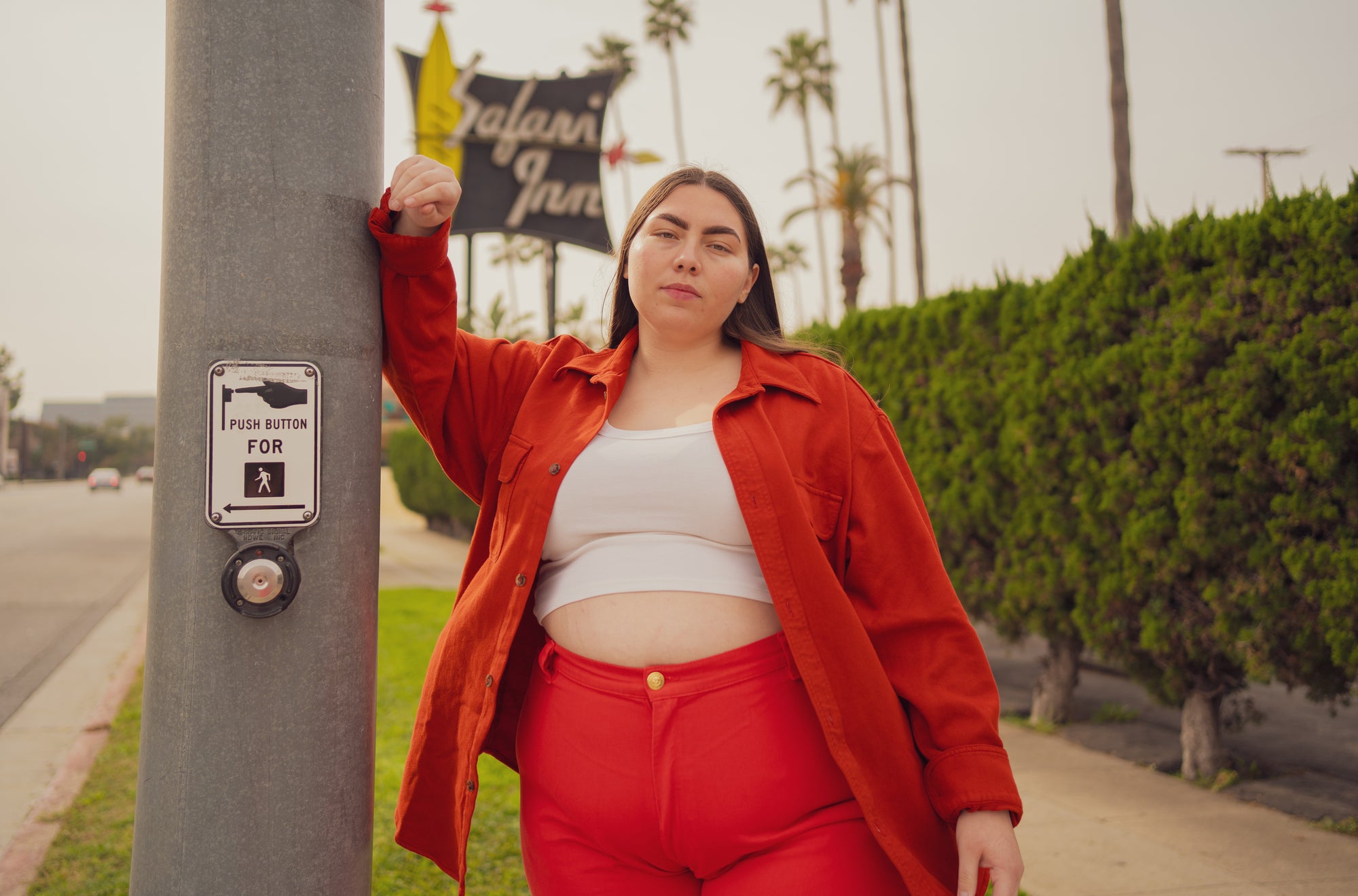 Marielena is wearing Flannel Overshirt in Paprika, Cropped Tank Top in Vintage Tee Off-White, and Bell Bottoms in Mustang Re