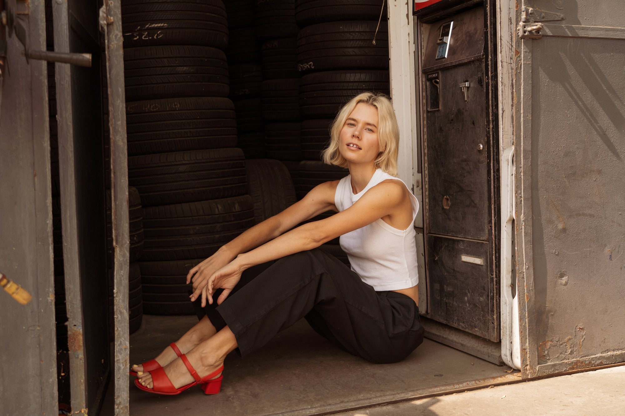 Madeline is wearing Muscle Tee in Vintage Tee Off-White and Mid-Rise Work Pants in Basic Black
