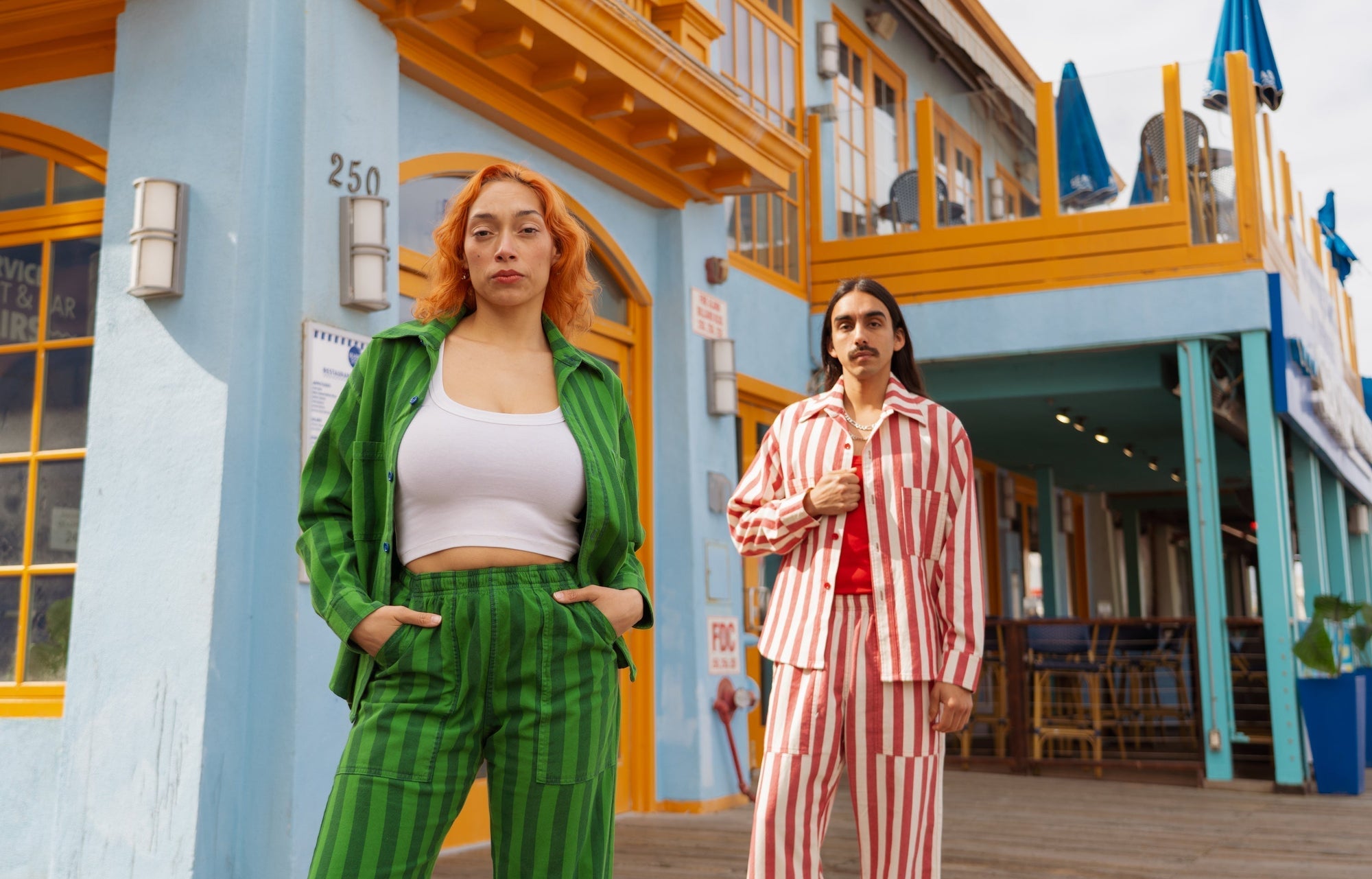 Anthony is wearing Summer Stripe Cropped Overshirts and Action Pants in Cherry Red. Tiara is wearing Summer Stripe Cropped Overshirts and Action Pants in Green on Green