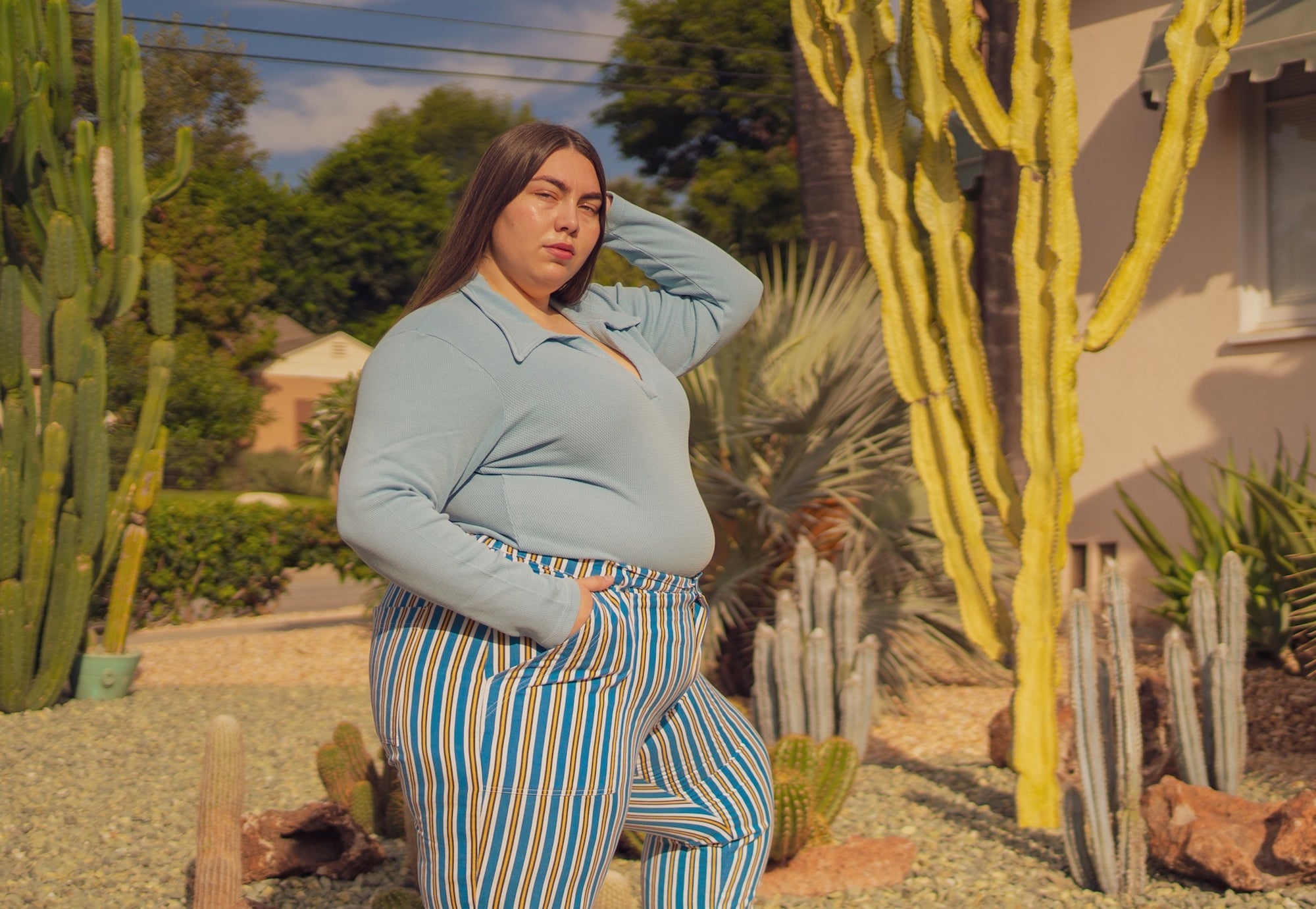 Marielena is wearing Long Sleeve Fisherman Polo in Baby Blue and Stripe Work Pants in Blue/Yellow