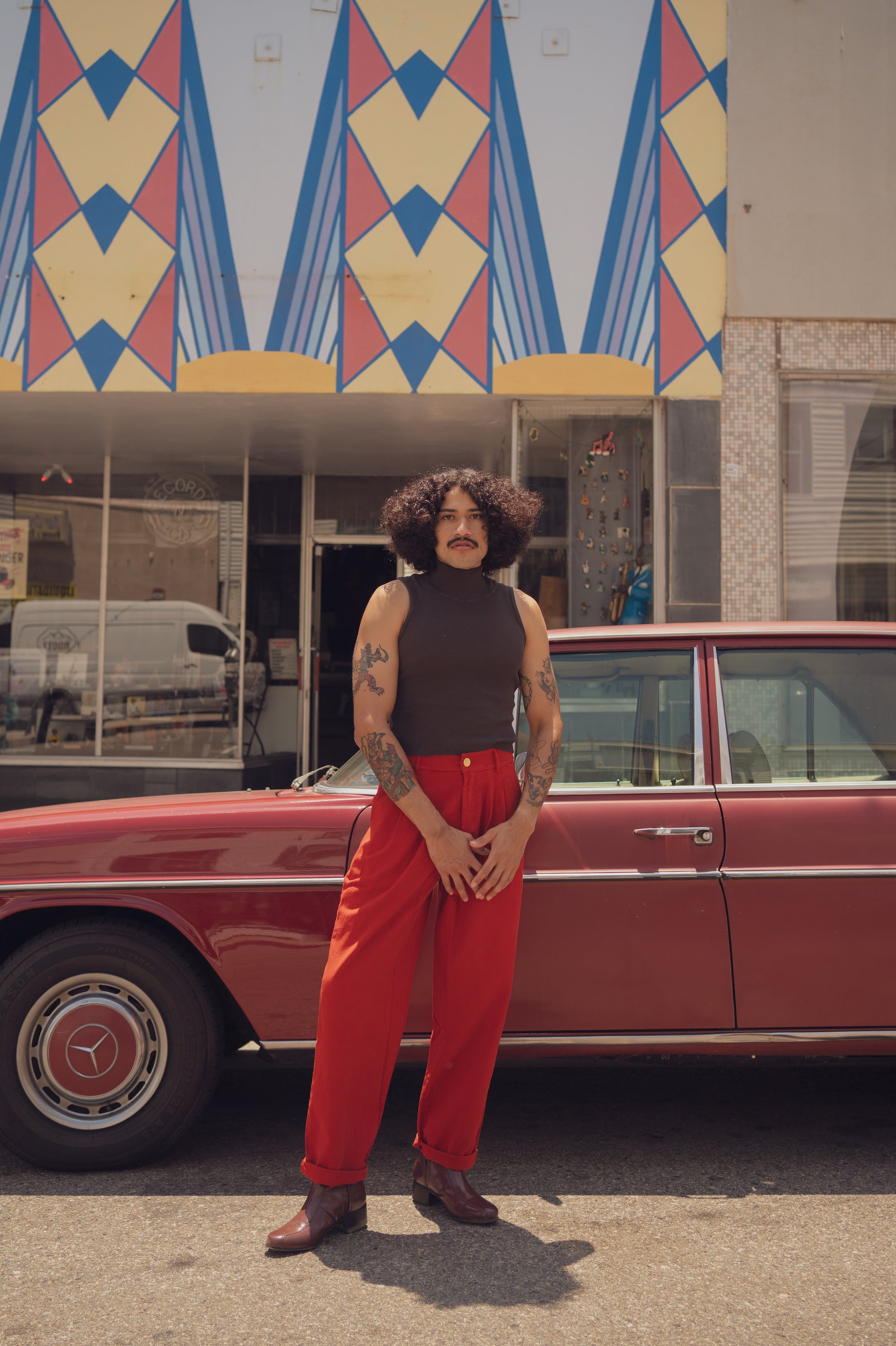 Jesse wearing Sleeveless Essential Turtleneck in Espresso Brown and Trouser Pants in Paprika