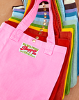 Shopper Tote Bag stacked on top of one another in a rainbow of hues