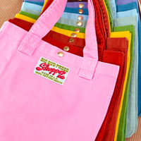 Shopper Tote Bag stacked on top of one another in a rainbow of hues