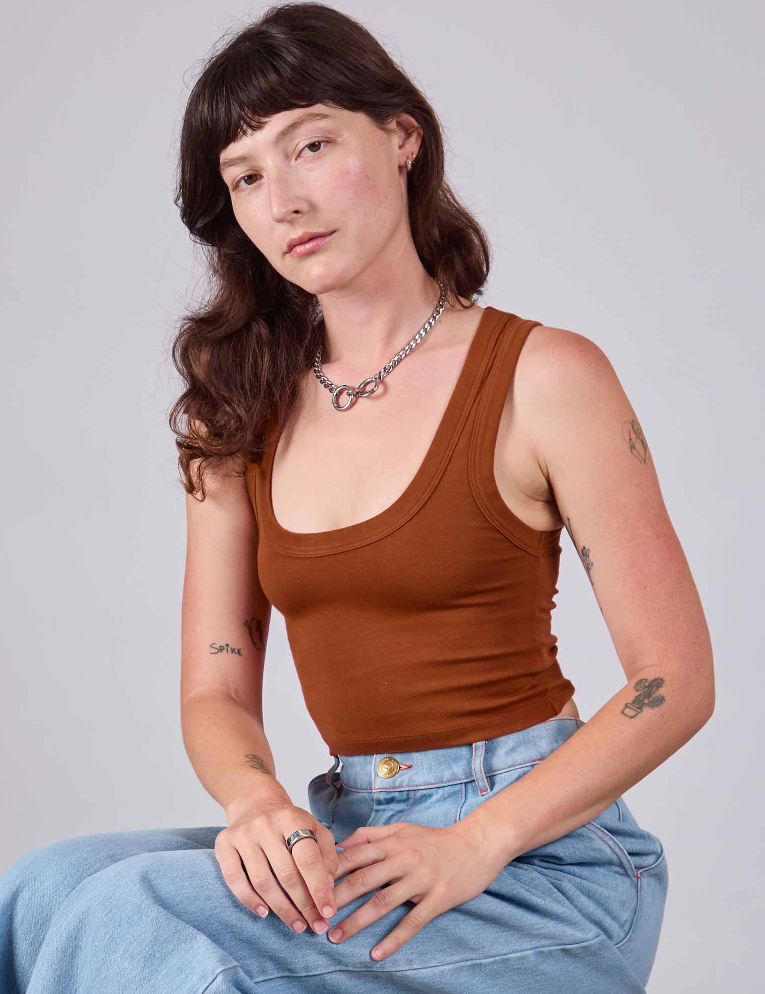 Alex is 5'8" and wearing P Cropped Tank Top in Burnt Terracotta