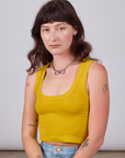 Alex is 5'8" and wearing P Cropped Tank Top in Golden Yellow