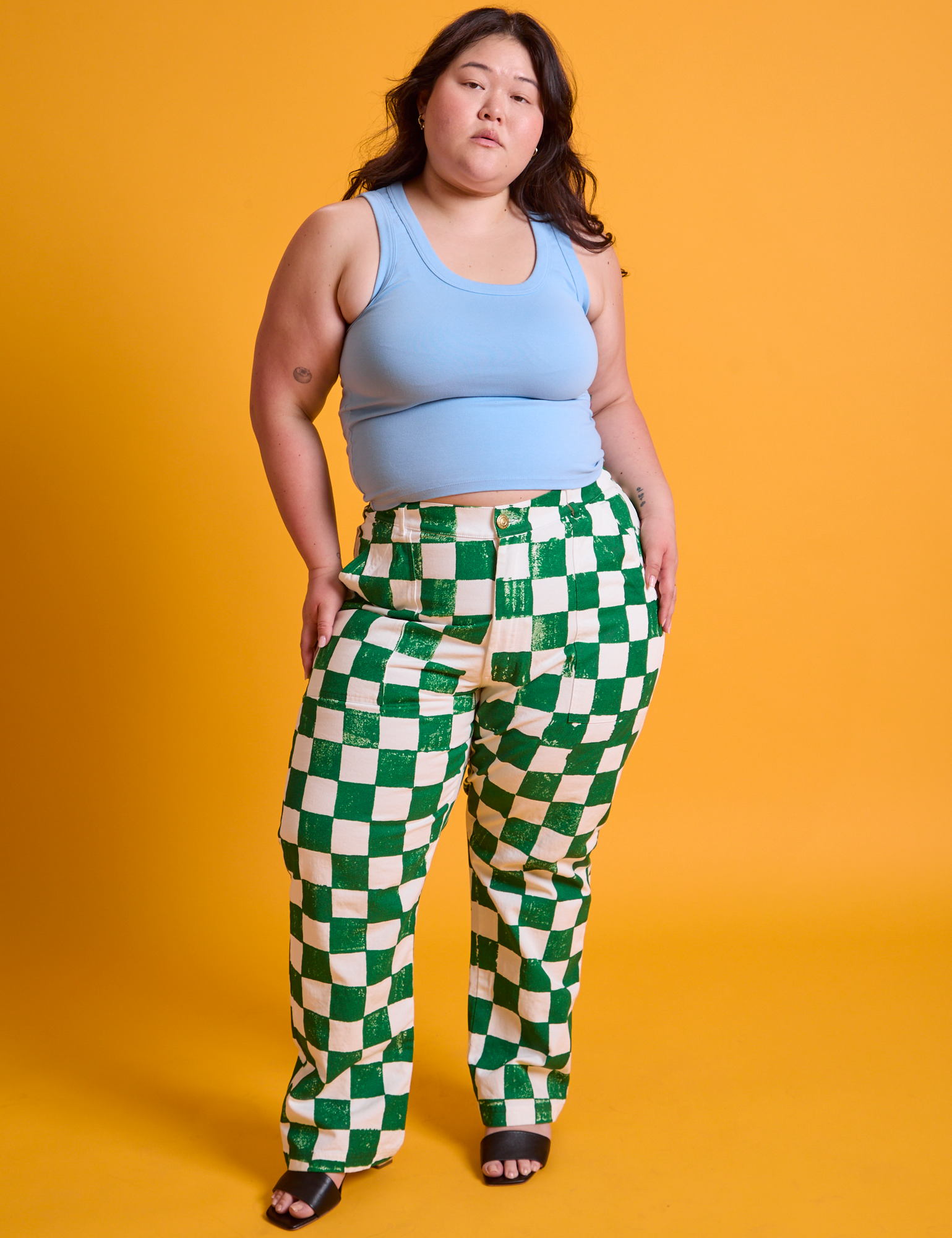 Ashley is 5'7" and wearing 1XL Checkerboard Work Pants in White/Green paired with baby blue Tank Top