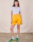 Alex is 5'8" and wearing XXS Sweat Shorts in Sunshine Yellow paired with a Jr. Varsity Tee in Stone White