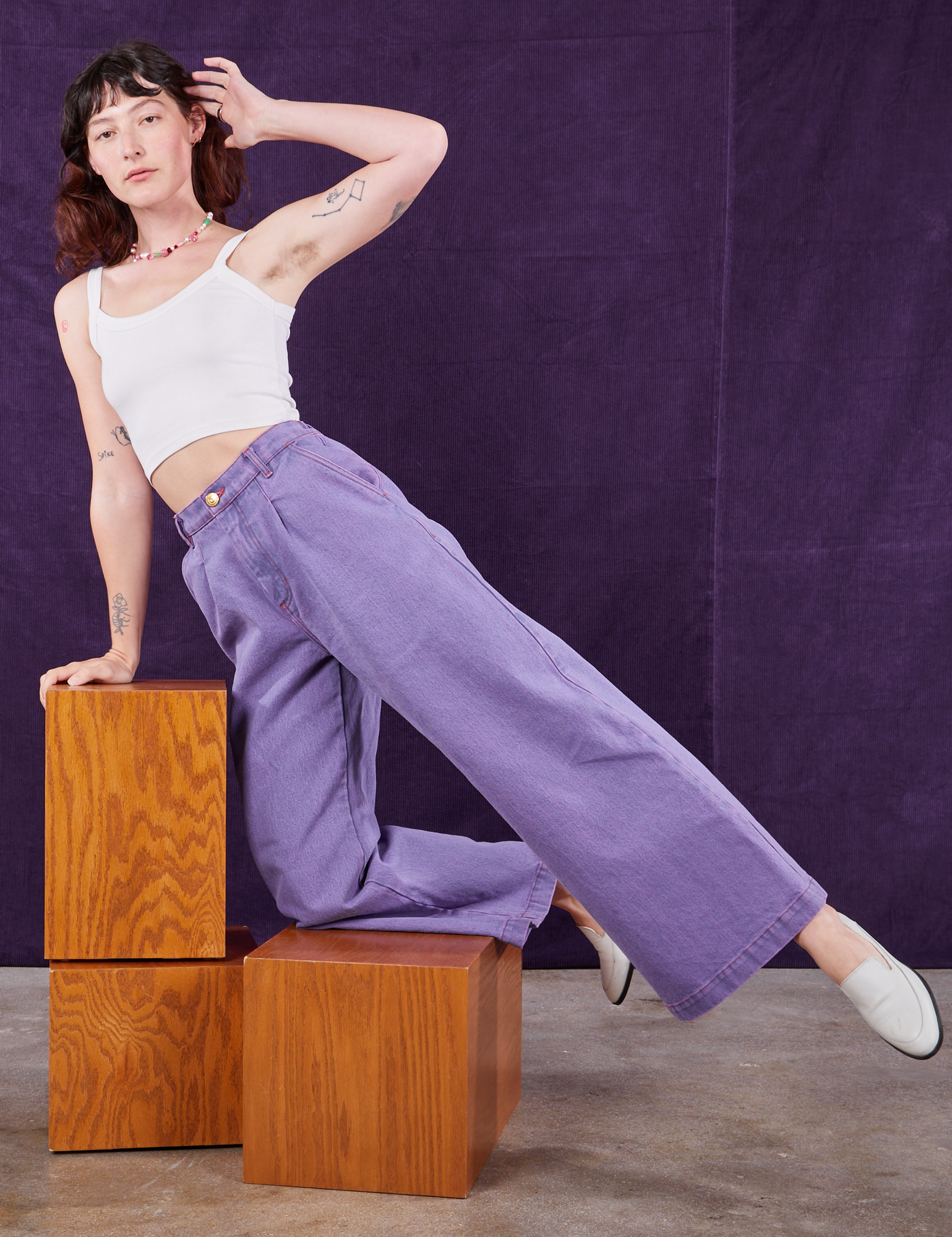 Alex is wearing Overdyed Wide Leg Trousers in Faded Grape and vintage off-white Cami