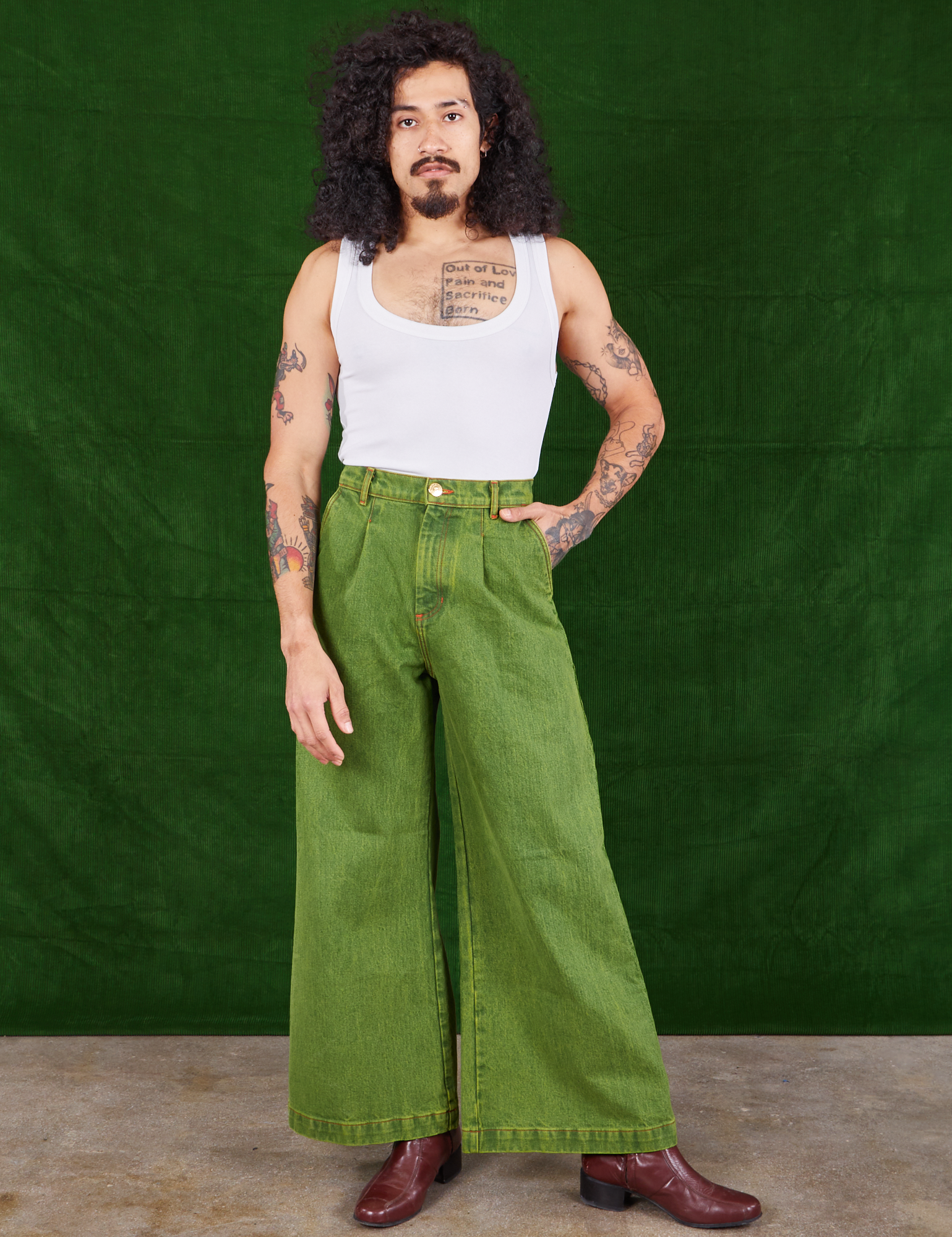 Jesse is 5'8" and wearing XXS Overdyed Wide Leg Trousers in Gross Green paired with vintage off-white Cropped Tank Top