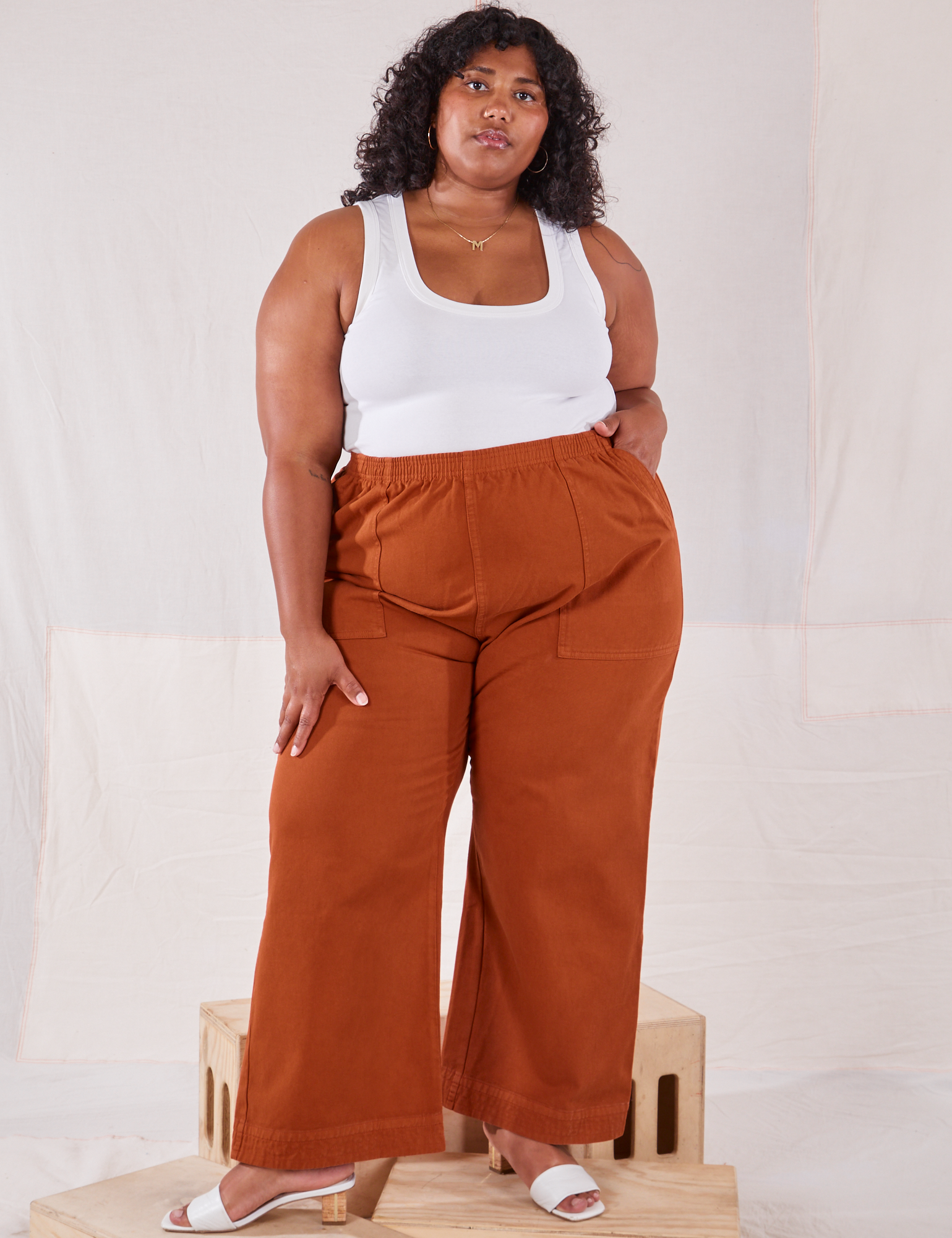 Morgan is 5'5" and wearing 2XL Action Pants in Burnt Terracotta and Cropped Tank Top in vintage tee off-white