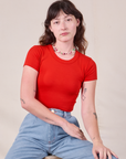 Alex is wearing Baby Tee in Mustang Red