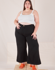 Marielena is 5'8" and wearing 2XL Bell Bottoms in Basic Black paired with a Cropped Cami in vintage tee off-white