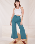 Alex is 5'8" and wearing XXS Bell Bottoms in Marine Blue paired with Halter Top in vintage tee off-white