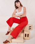 Alex is wearing Bell Bottoms in Mustang Red and Cropped Tank Top in vintage tee off-white