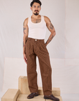 Jesse is 5'8" and wearing XS Checker Trousers in Brown & Black paired with a Tank Top in vintage tee off-white on Jesse
