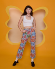 Alex is 5’8” and wearing XXS Butterfly Kaleidoscope Work Pants paired with a vintage tee white Cropped Tank
