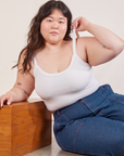 Ashley is wearing Cropped Cami in Vintage Tee Off-White and dark wash Carpenter Jeans