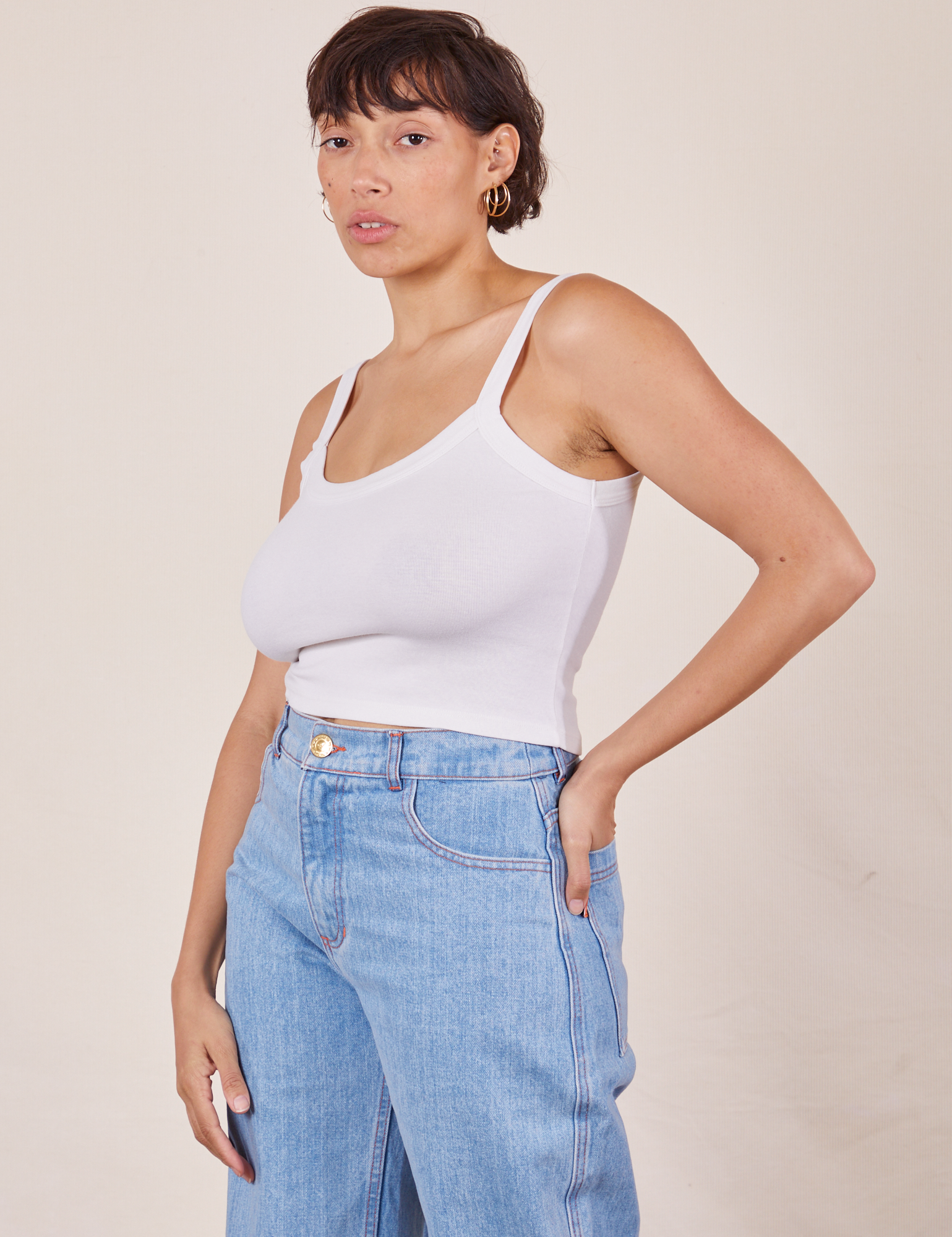 Tiara is 5'4" and wearing XS Cropped Cami in Vintage Tee Off-White paired with light wash Sailor Jeans