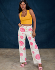 Kandia is 5'3" and wearing XS Paintstamped Work Pants in Bubblegum paired with a mustard yellow Cropped Tank