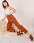 Alex is wearing Carpenter Jeans in Burnt Terracotta and Cropped Cami in vintage tee off-white