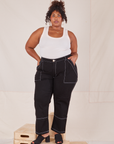 Morgan is 5'5" and wearing 1XL Carpenter Jeans in Black paired with vintage off-white Tank Top