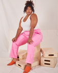 Morgan is 5'5" and wearing 1XL Carpenter Jeans in Bubblegum Pink paired with Tank Top in vintage tee off-white
