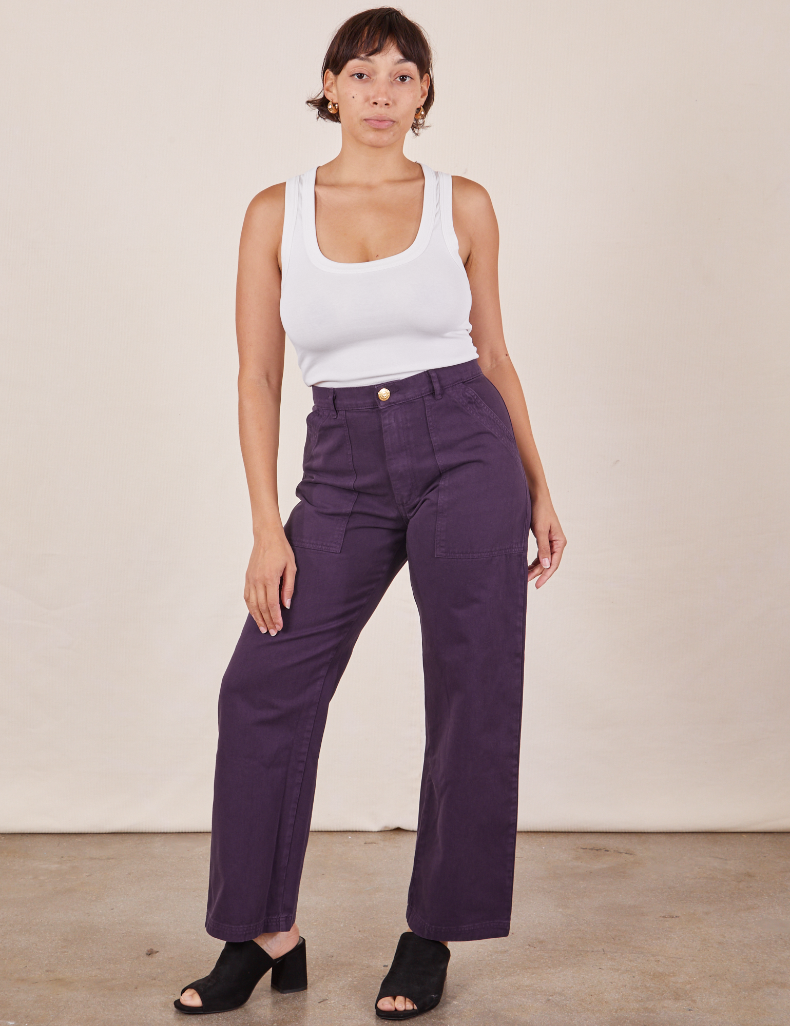 Tiara is 5&#39;4&quot; and wearing S Work Pants in Nebula Purple paired with Cropped Tank Top in vintage tee off-white