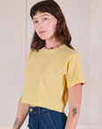 Alex is 5'8" and wearing P Cropped Burly Tee in Butter Yellow