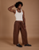 Jerrod is 6’3” and wearing M Drop Pocket Cargo Pants in Fudgesicle Brown paired with a Tank Top in vintage tee white