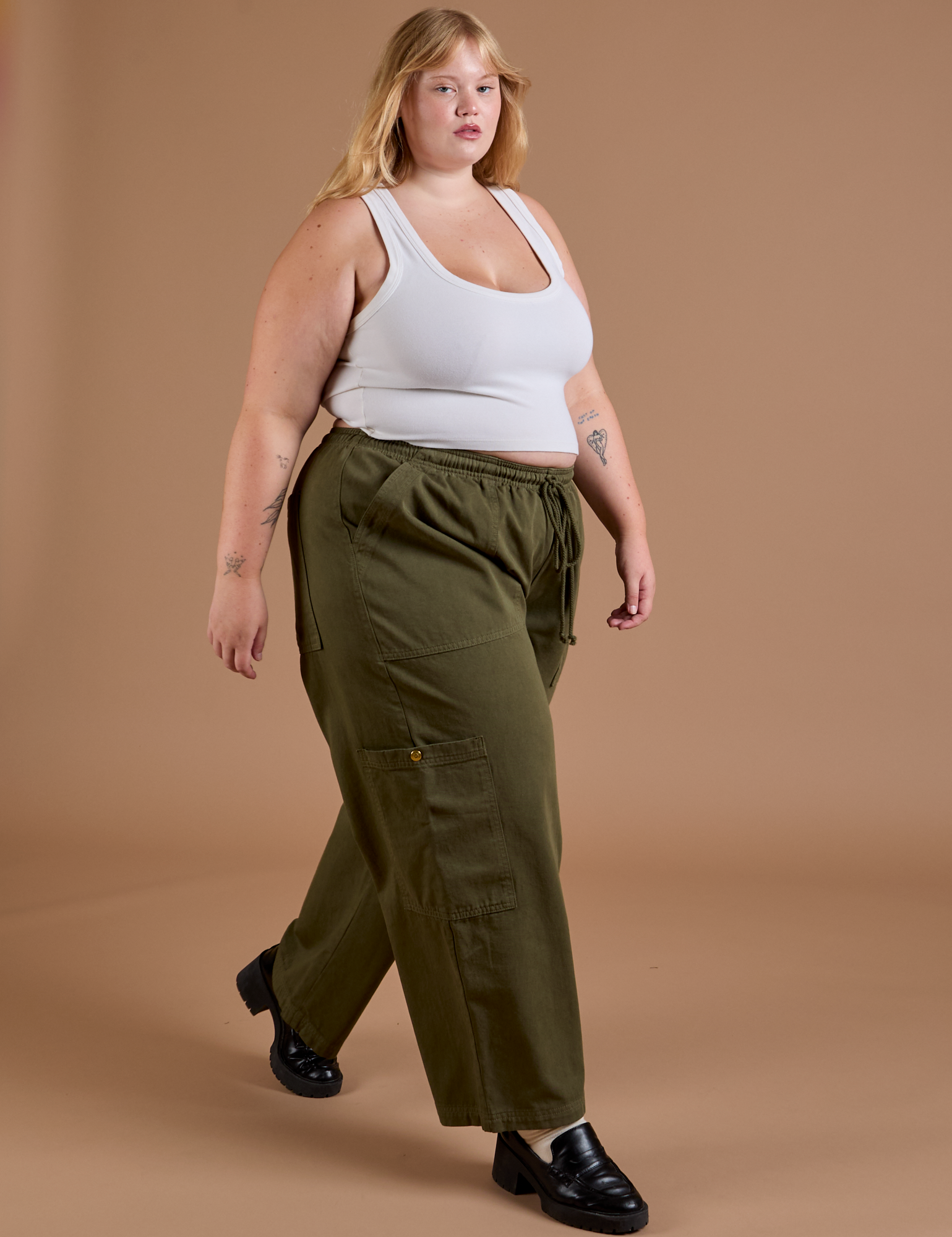Juliet is wearing Drop Pocket Cargo Pants in Surplus Green paired with a Cropped Tank Vintage Tee White