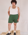 Miguel is 6’0” and wearing 1XL Easy Shorts in Dark Emerald Green paired with a Tank Top in vintage tee off-white