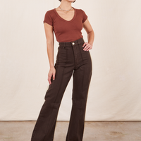 Soraya is 5'2" and wearing XXS Petite Western Pants in Espresso Brown paired with fudgesicle brown V-Neck Tee