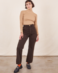 Soraya is 5'2" and wearing Petite XXS Work Pants in Espresso Brown paired with Essential Turtleneck in Tan