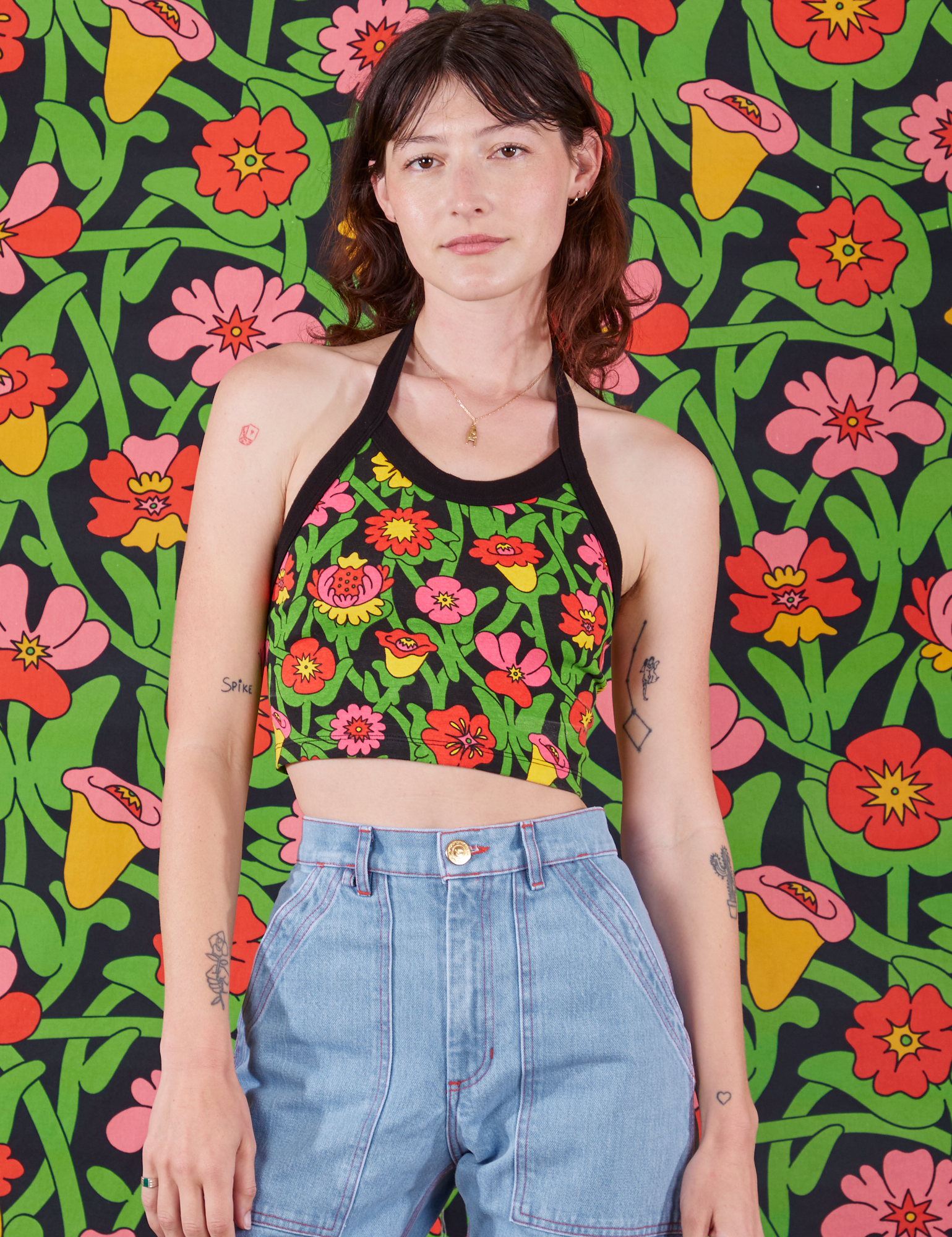 Alex is 5'8" and wearing XXS Halter Top in Flower Tangle paired with light wash Carpenter Jeans