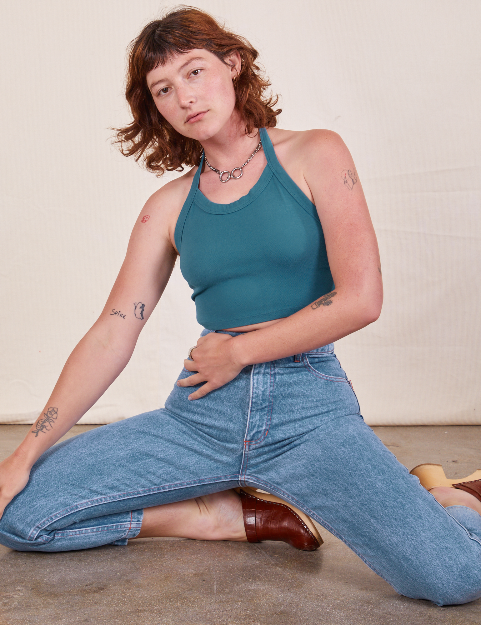 Alex is 5&#39;8&quot; and wearing P Halter Top in Marine Blue paired with light wash Frontier Jeans