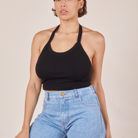 Tiara is 5'4" and wearing XS Halter Top in Basic Black paired with light wash Sailor Jeans
