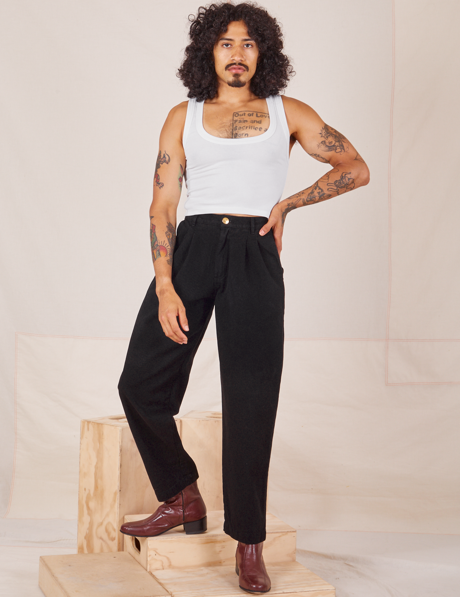 Jesse is 5&#39;8&quot; and wearing XXS Heavyweight Trousers in Basic Black paired with Cropped Tank Top in vintage tee off-white