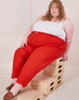 Catie is 5'11" and wearing 4XL Heavyweight Trousers in Mustang Red paired with Cropped Cami in vintage tee off-white