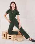 Alex is 5'8" and wearing XXS Heritage Short Sleeve Jumpsuit in Swamp Green
