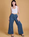 Alex is 5'8" and wearing XXS Heritage Wide Leg Trousers in French Blue paired with vintage tee white Cropped Tank