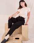 Alex is wearing Heritage Trousers in Basic Black and Organic Vintage Tee in vintage tee off-white