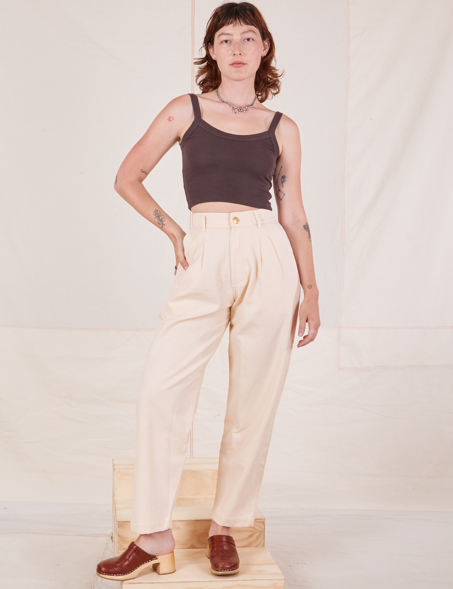 Alex is 5&#39;8&quot; and wearing XXS Heritage Trousers in Vintage Off-White paired with espresso brown Cropped Cami
