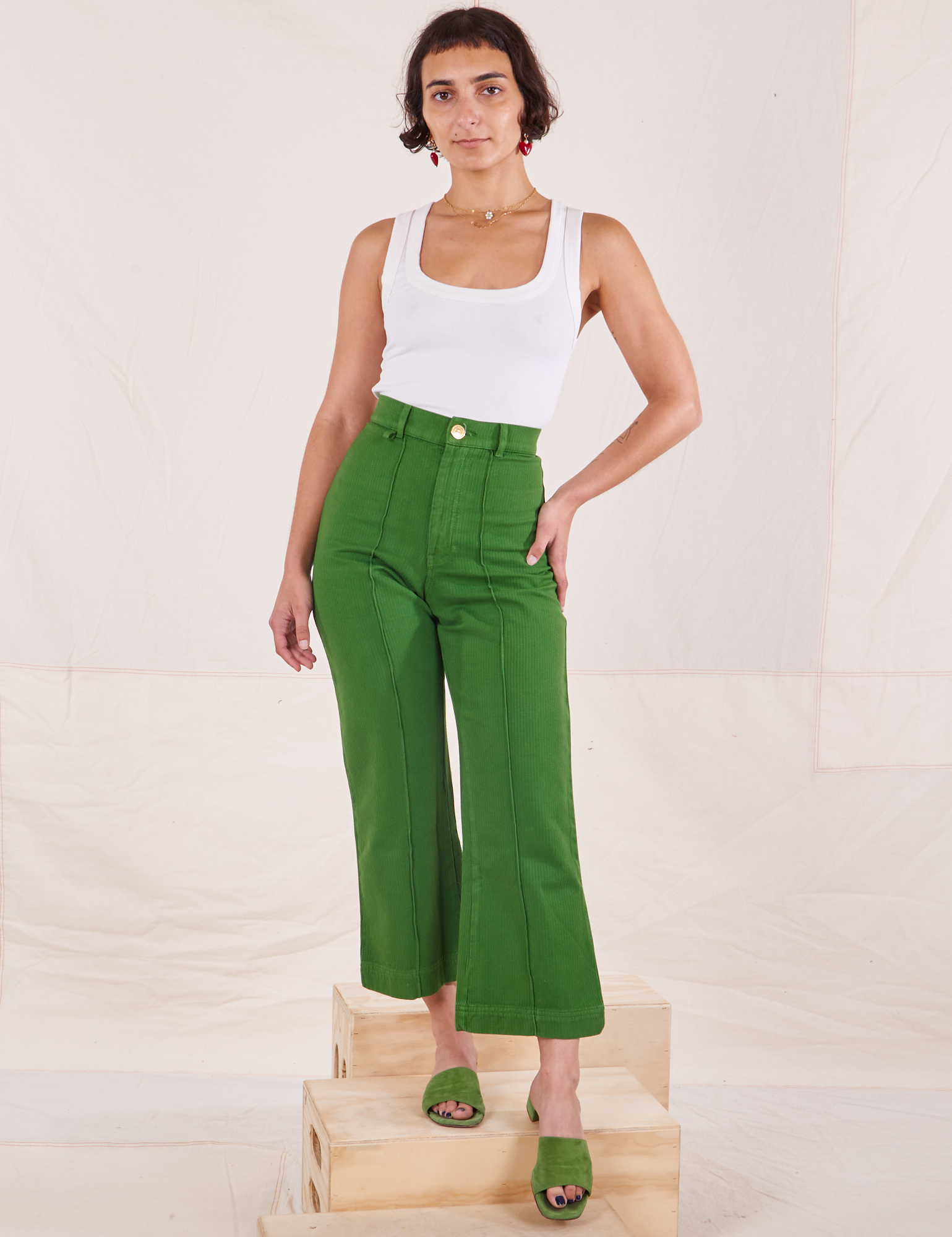 Soraya is 5&#39;3&quot; and wearing XXS Petite Heritage Westerns in Lawn Green paired with Cropped Tank Top in vintage tee off-white