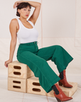 Tiara is wearing Bell Bottoms in Hunter Green paired with a Tank Top in vintage tee off-white