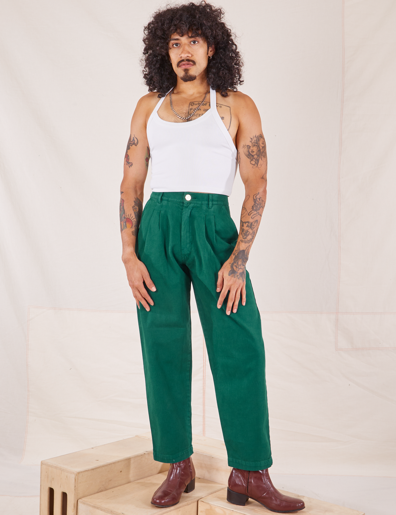 Jesse is 5&#39;8&quot; and wearing XXS Heavyweight Trousers in Hunter Green paired with Halter Top in vintage tee off-white